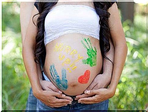 Baby bump with colored hands