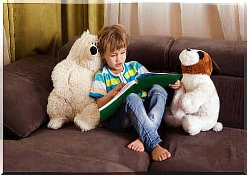 child on the sofa reading a children's book 