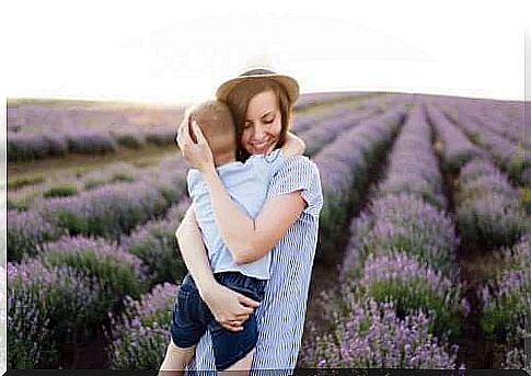 Mom hugging her son in a lavender field