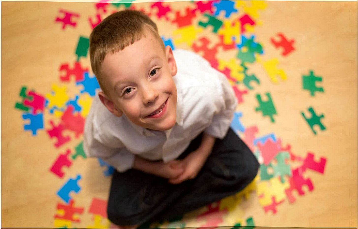 Smiling child and puzzle pieces.