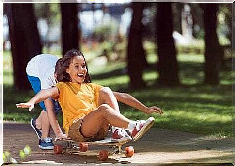 Children playing with a skateboard.