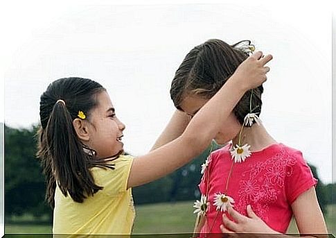 girl-gives-necklace-of-flowers-to-friend