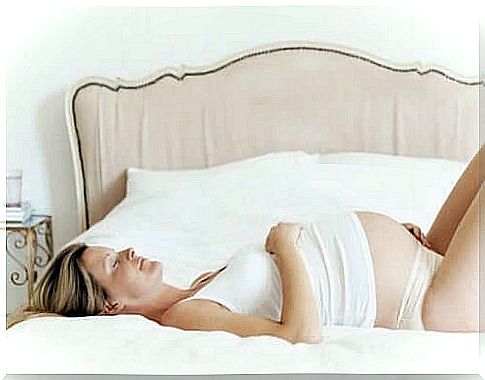 pregnant woman resting lying on the bed