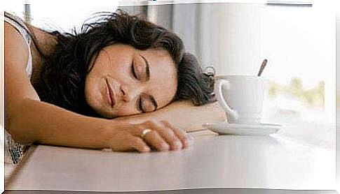 Sleeping woman with coffee.  Japanese method against laziness.