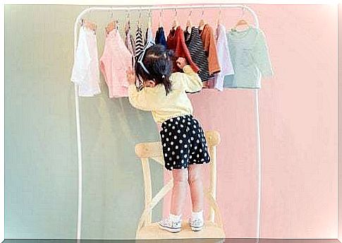 Little girl choosing clothing