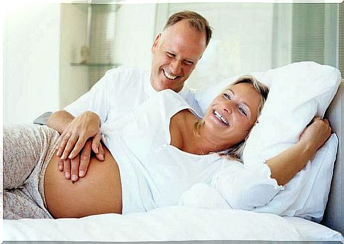 Pregnant woman smiles together with her husband