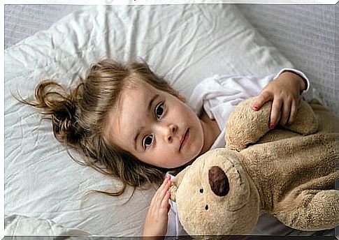 Little girl awake in her bed