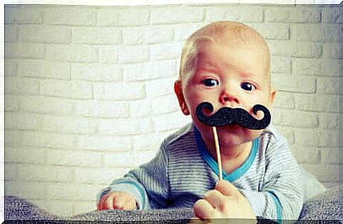 Infant baby with fake mustache