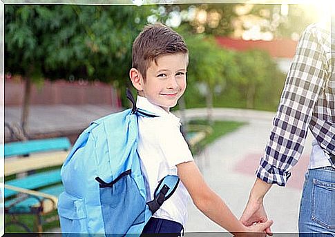 Child with backpack goes to school